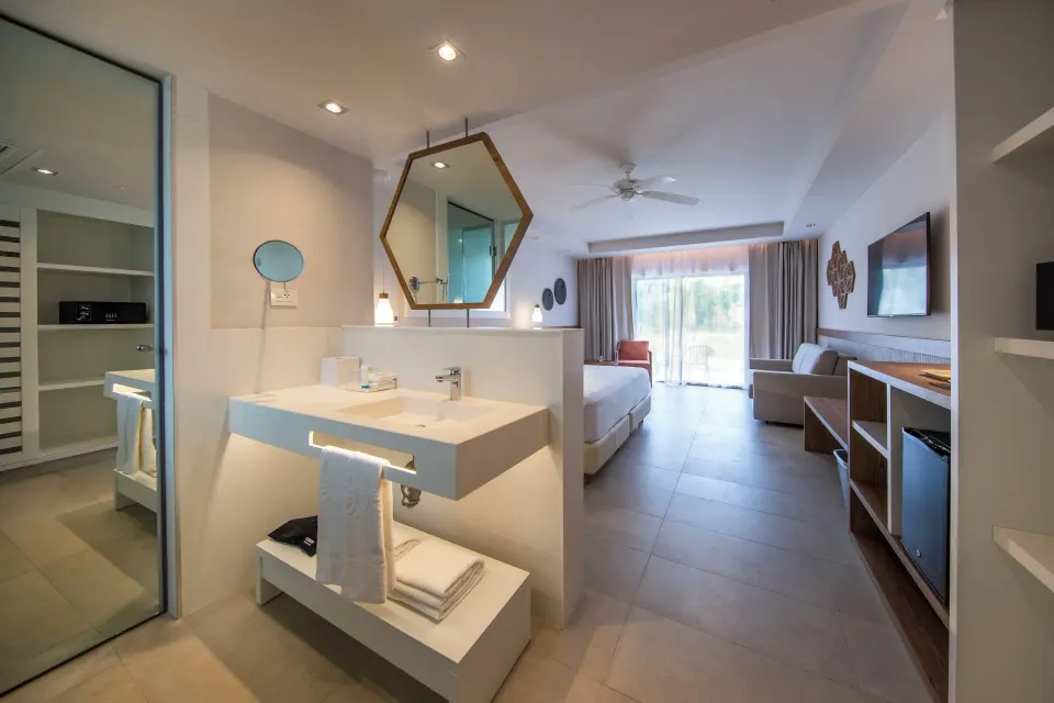 Open-plan Family Suite with vanity and king bed at Bahia Principe Grand Tulum