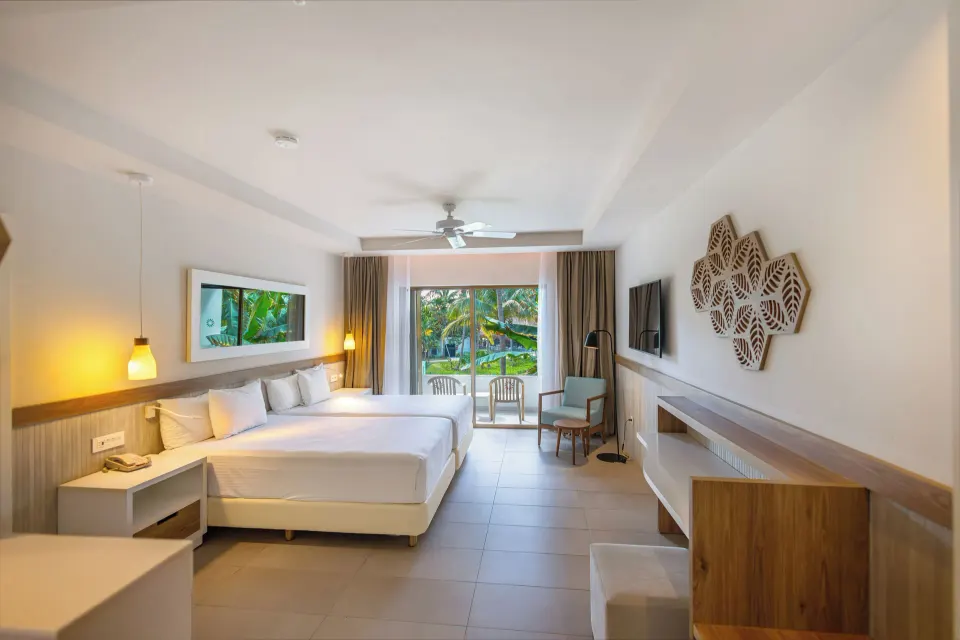 Spacious Junior Suite with king bed and balcony view at Bahia Principe Grand Tulum