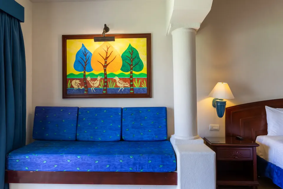 Junior Suite blue sofa alcove and bedside lamp at Bahia Principe Grand Tulum