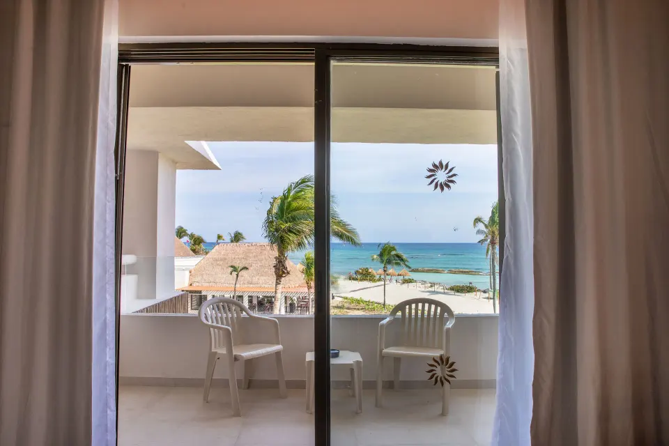 Balcony view from Premium Room (Superior 2+2) showing ocean and palm trees at Bahia Principe Grand Tulum