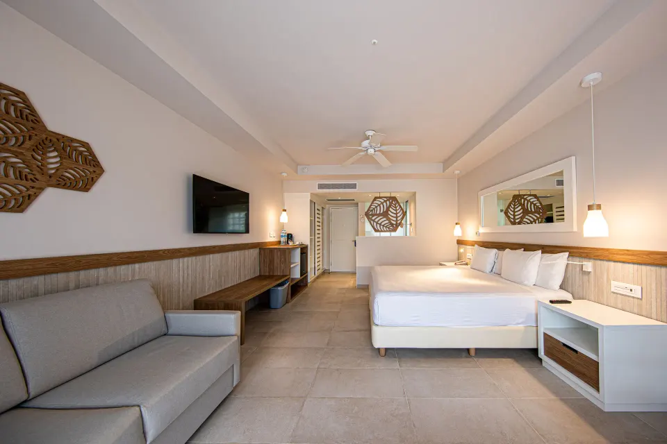 Spacious Premium Room (Superior 2+2) with king bed and sofa at Bahia Principe Grand Tulum