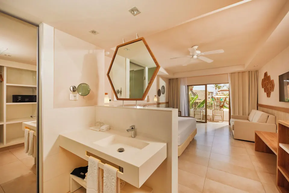 View from vanity toward bed and balcony in Premium Room at Bahia Principe Grand Tulum