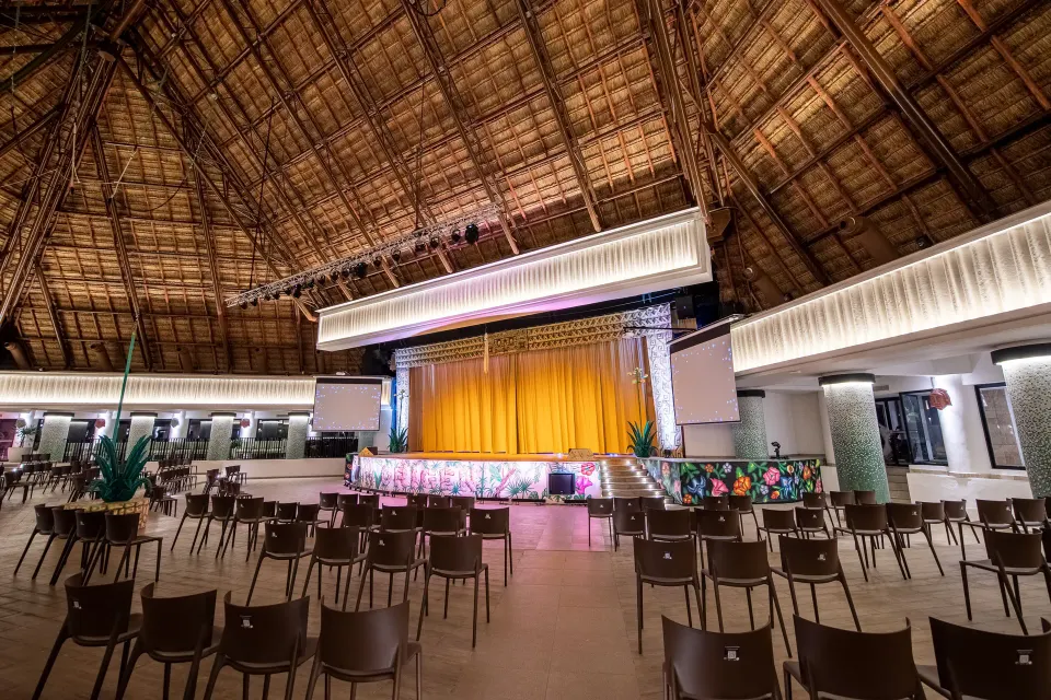 Empty palapa-roofed show stage and seating at Bahia Principe Grand Tulum
