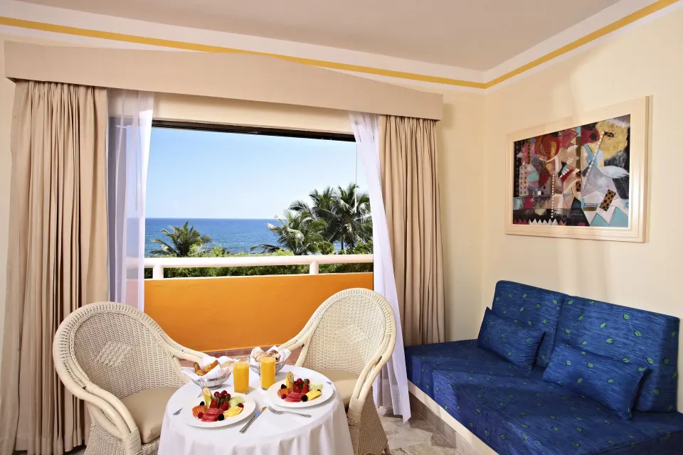 Balcony seating with ocean view from a guest room at Bahia Principe Luxury Akumal