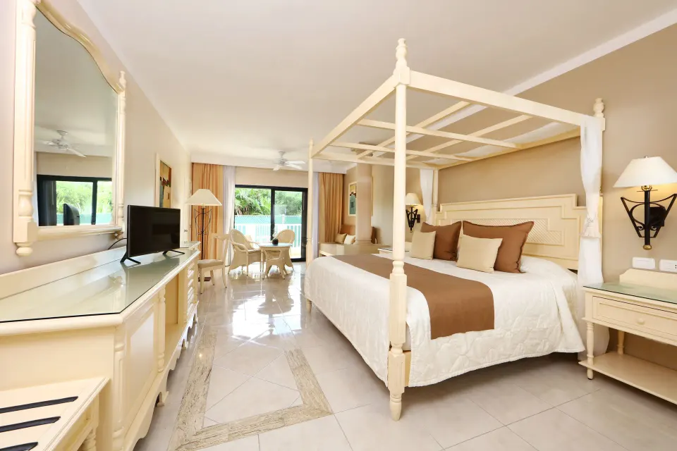 Spacious junior suite with four-poster king bed at Bahia Principe Luxury Akumal