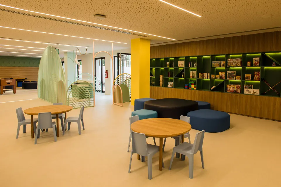 Bright indoor kids play area with seating at Bahia Principe Luxury Akumal