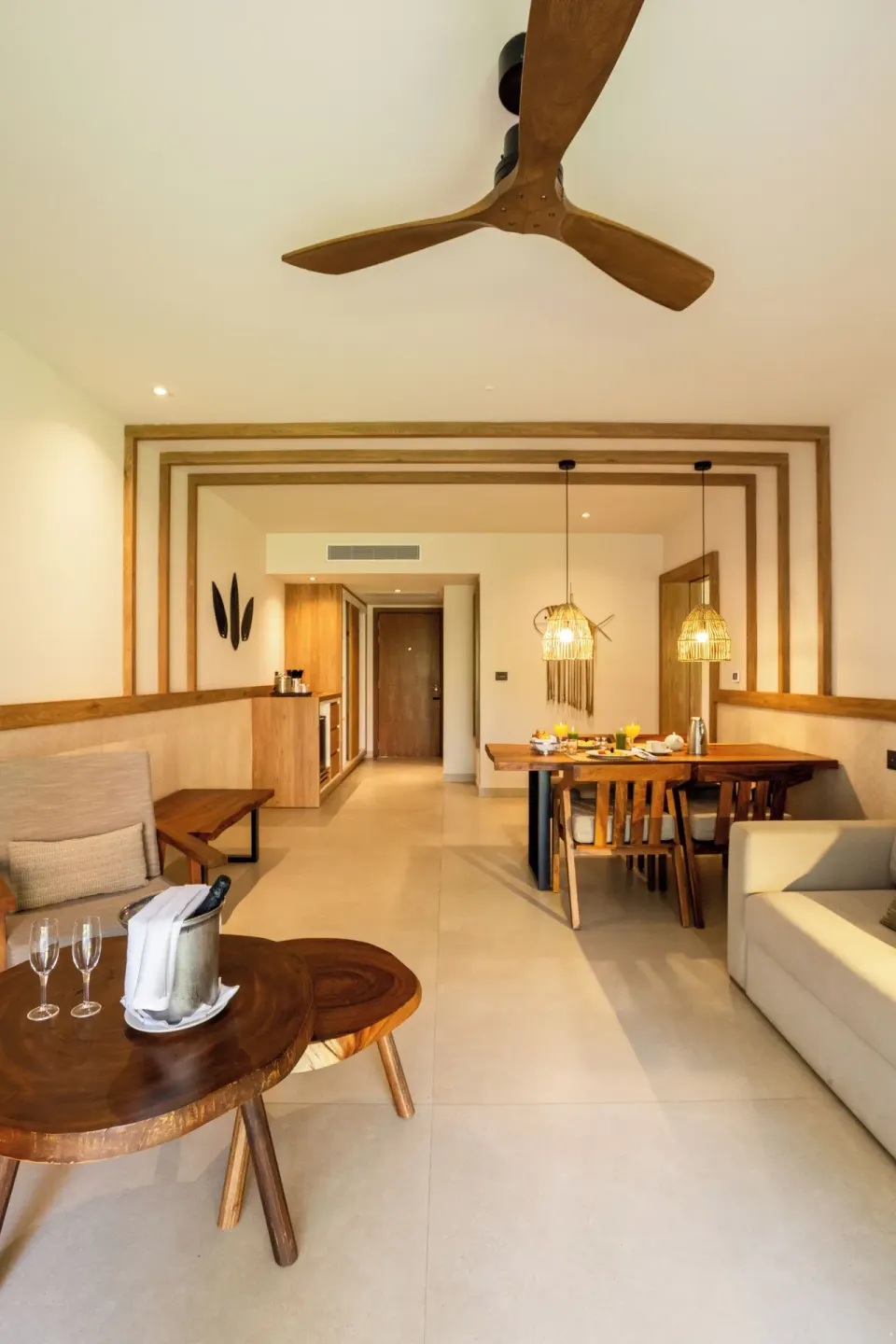 Wide view of a junior suite living and dining space at Bahia Principe Luxury Akumal