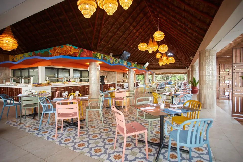 Colorful open-air restaurant seating with patterned tile floor at Bahia Principe Luxury Akumal