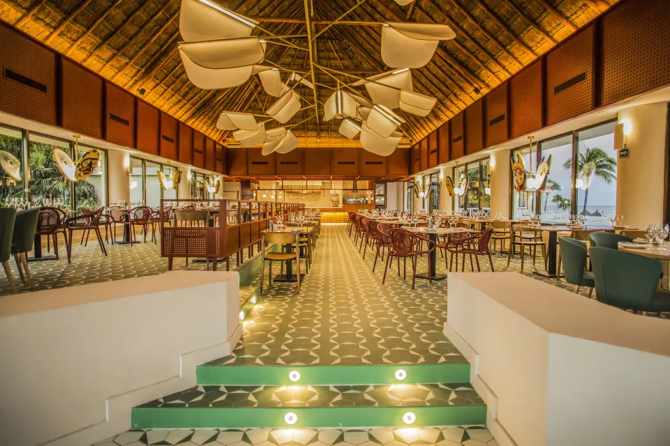Spacious dining room with patterned floor and ocean views at Bahia Principe Luxury Akumal