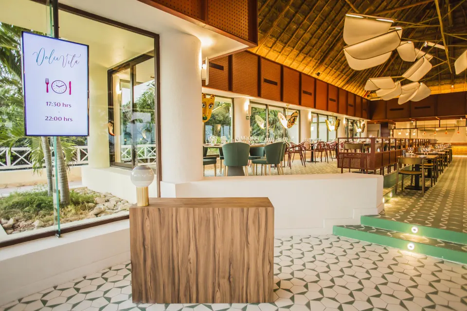 Restaurant entrance with host podium and signage at Bahia Principe Luxury Akumal