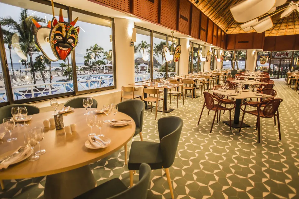 Main dining area with patterned floor and ocean view at Bahia Principe Luxury Akumal
