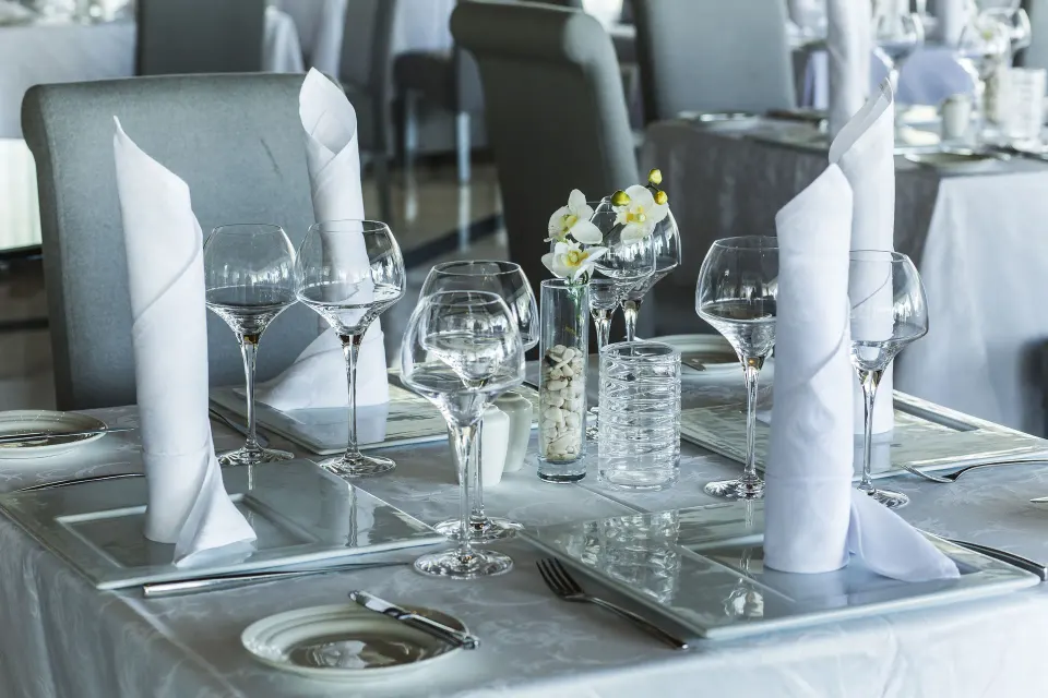Close-up table setting with folded napkins and glassware at Bahia Principe Luxury Akumal