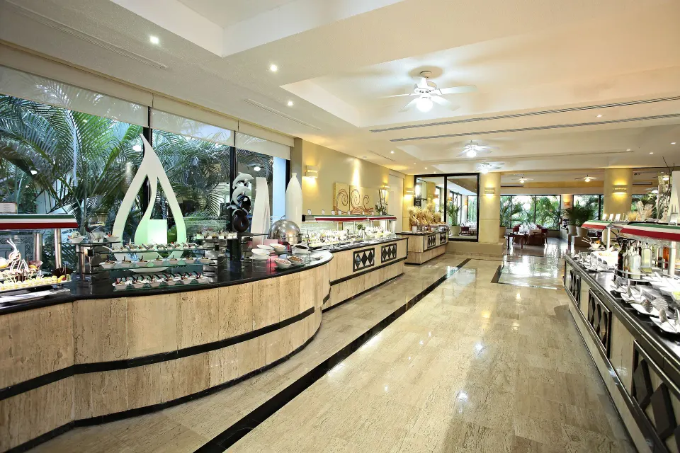 Long buffet line with food stations in a marble-floored dining area at Bahia Principe Luxury Akumal