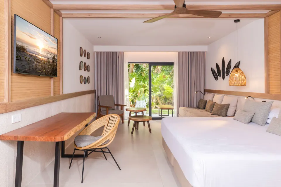 Junior Room Deluxe Swim Up bright room with seating and garden view at Bahia Principe Luxury Akumal