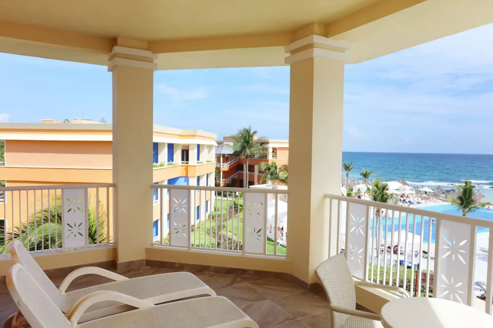 Balcony with lounge chairs and partial ocean view from Junior Room (Deluxe) at Bahia Principe Luxury Akumal