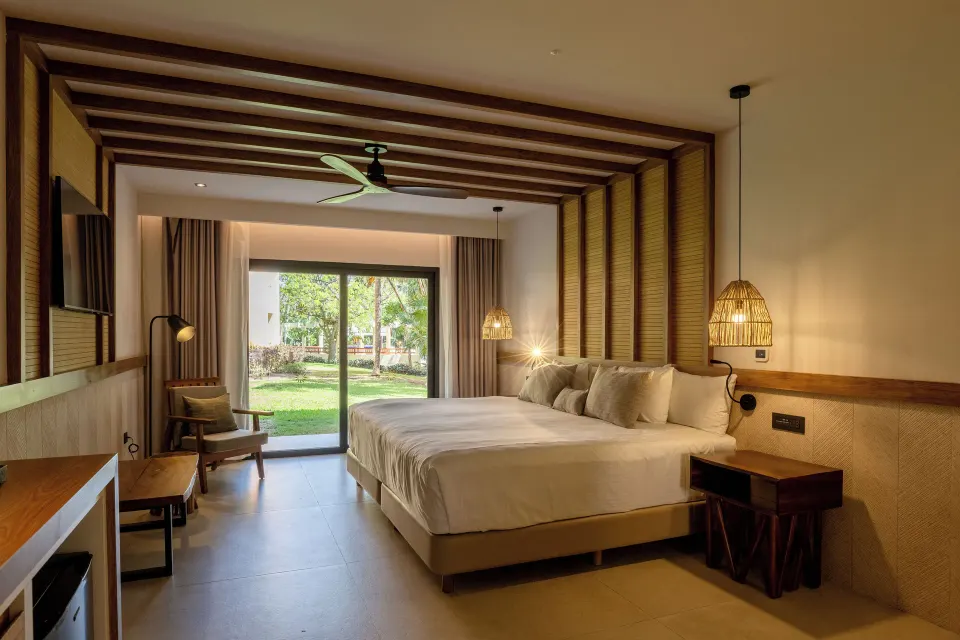 Junior Suite with king bed and garden view sliding doors at Bahia Principe Luxury Akumal