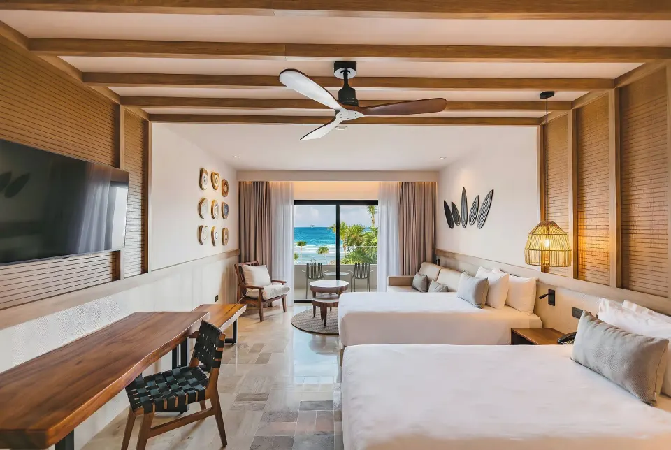 Junior Suite oceanfront with two double beds and balcony view at Bahia Principe Luxury Akumal