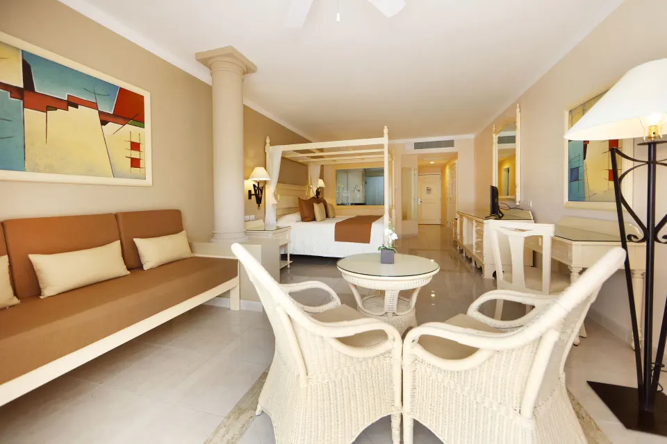 Spacious Junior Suite interior with king bed and seating area at Bahia Principe Luxury Akumal