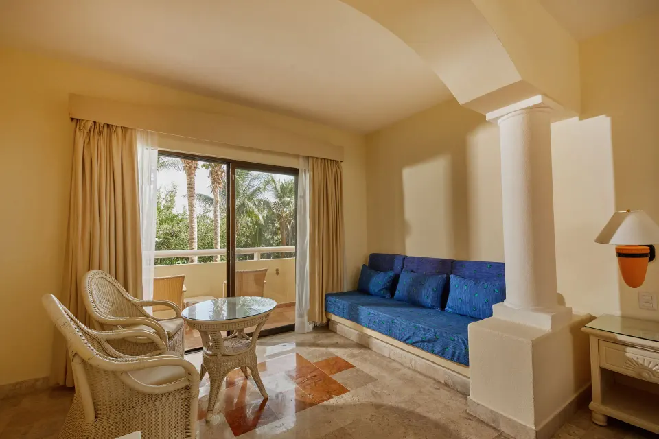 Balcony seating and built‑in sofa in a Junior Suite at Bahia Principe Luxury Akumal