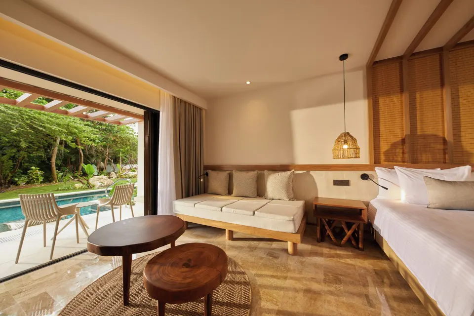 Junior Suite Swim Up seating area and terrace opening onto pool at Bahia Principe Luxury Akumal