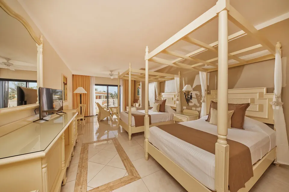 Spacious Junior Suite with two canopy beds and balcony at Bahia Principe Luxury Akumal
