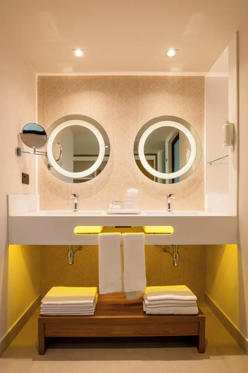 Double vanity with illuminated round mirrors in the bathroom of a two‑bedroom suite at Bahia Principe Luxury Akumal