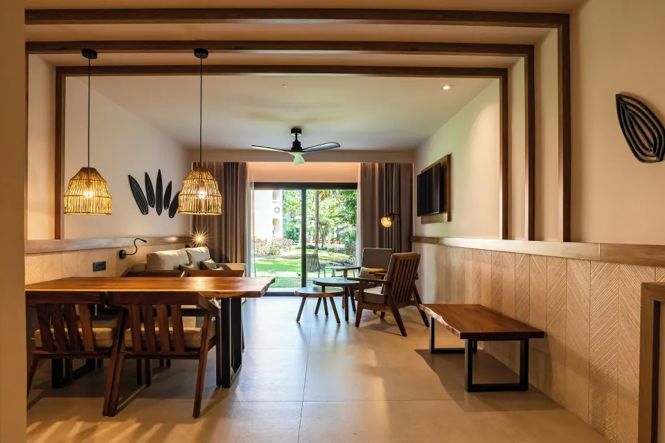 Living and dining area of a two‑bedroom suite with garden terrace at Bahia Principe Luxury Akumal