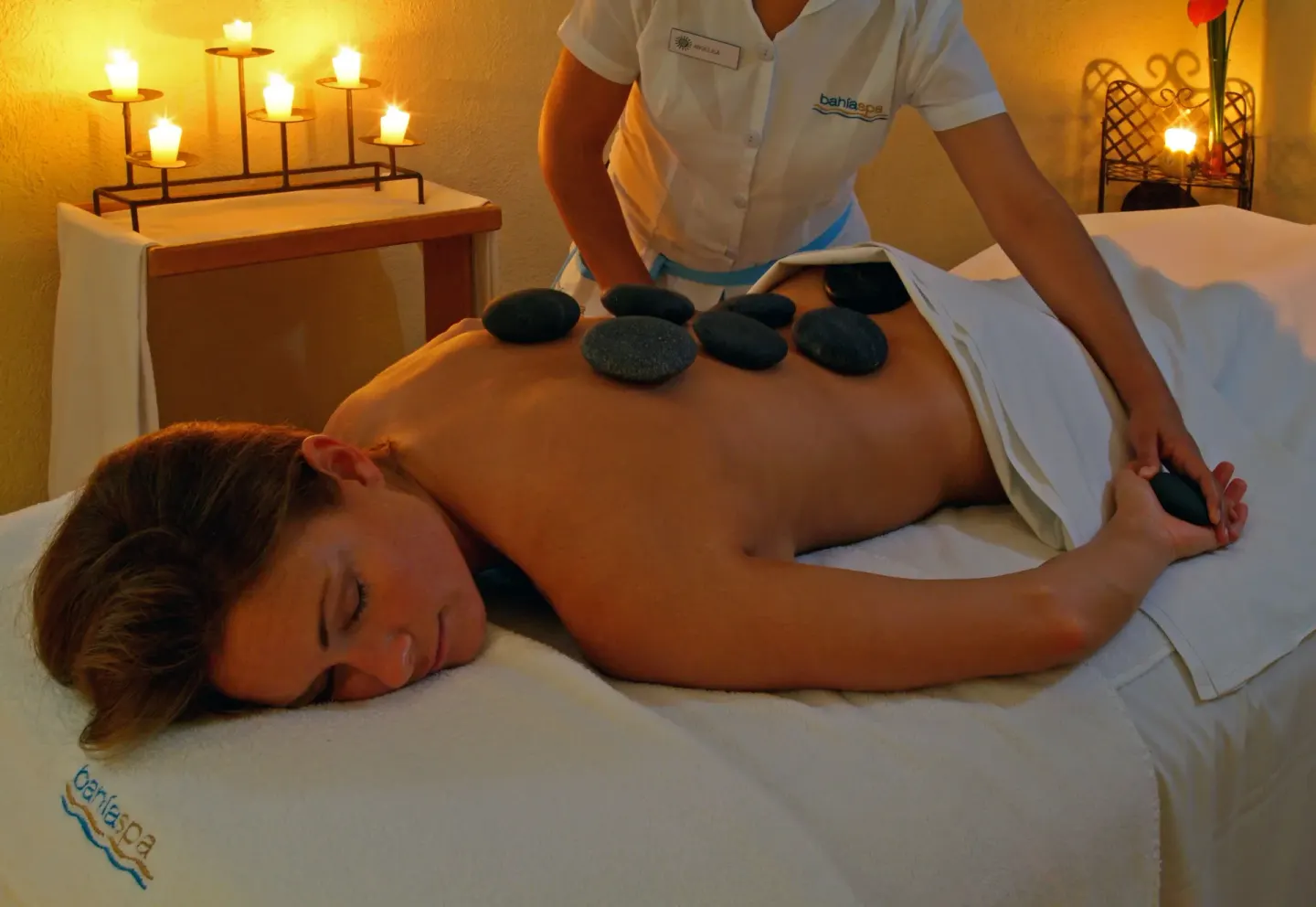 Hot stone massage treatment in the spa at Bahia Principe Luxury Bouganville.