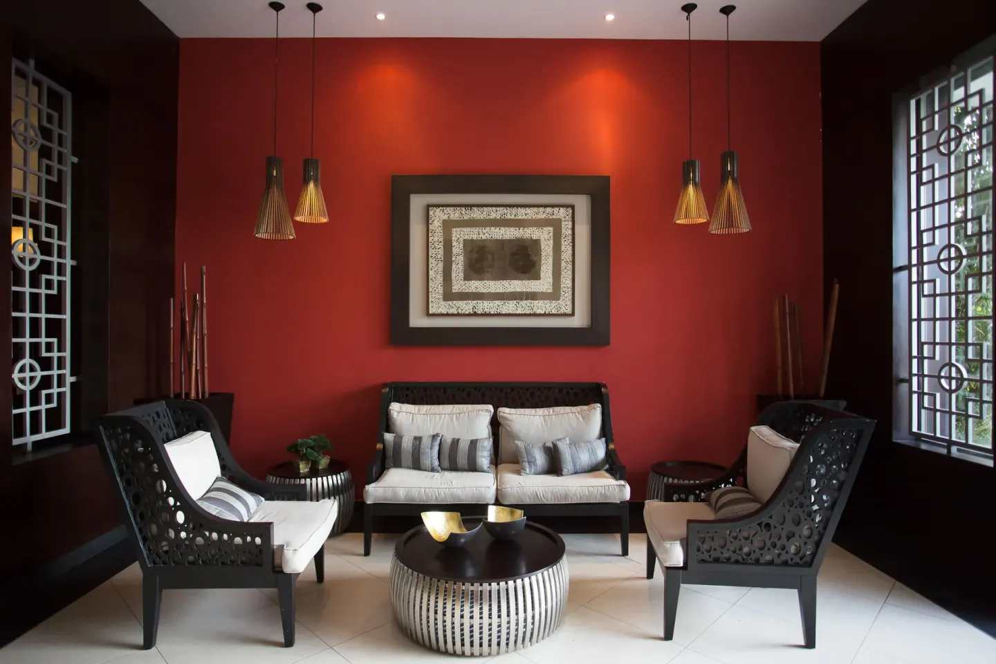Red-walled lounge seating area at Bahia Principe Luxury Bouganville.