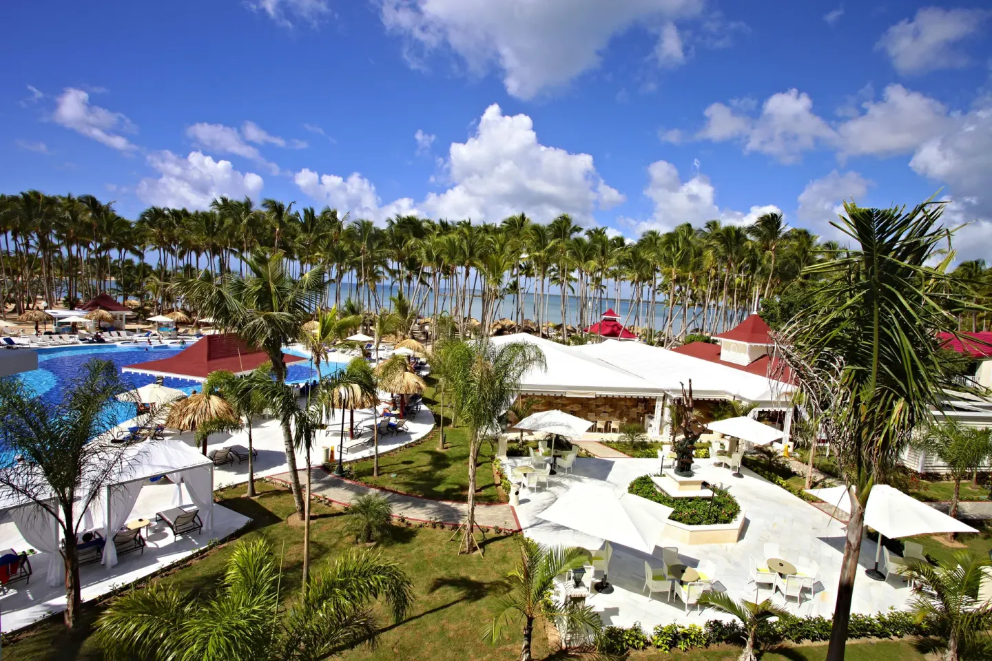 Resort gardens, pool, and beach palms at Bahia Principe Luxury Bouganville.
