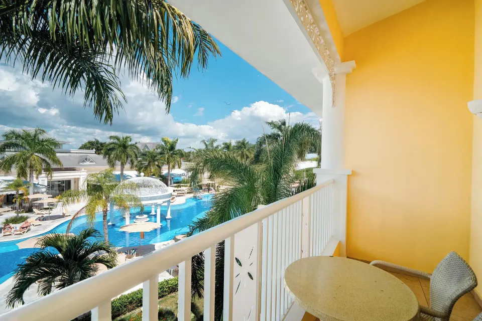 Junior Suite balcony beside the pool at Bahia Principe Luxury Bouganville.