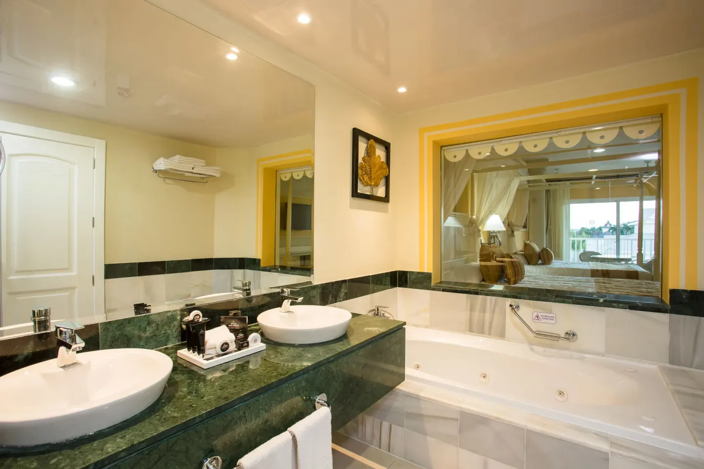 Junior Suite deluxe bathroom with double sinks and jetted tub at Bahia Principe Luxury Bouganville.