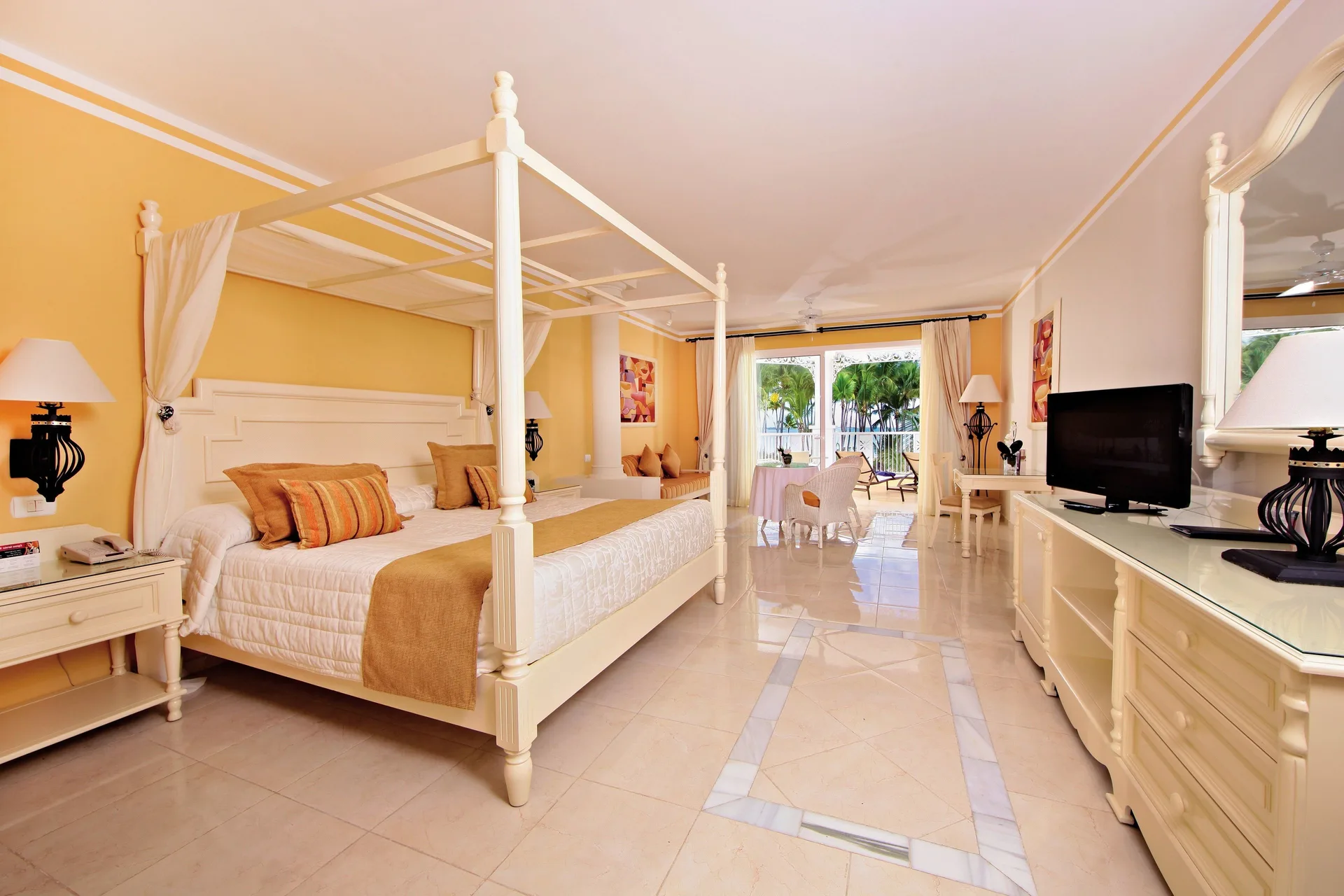 Junior Suite deluxe room with canopy bed and balcony at Bahia Principe Luxury Bouganville.