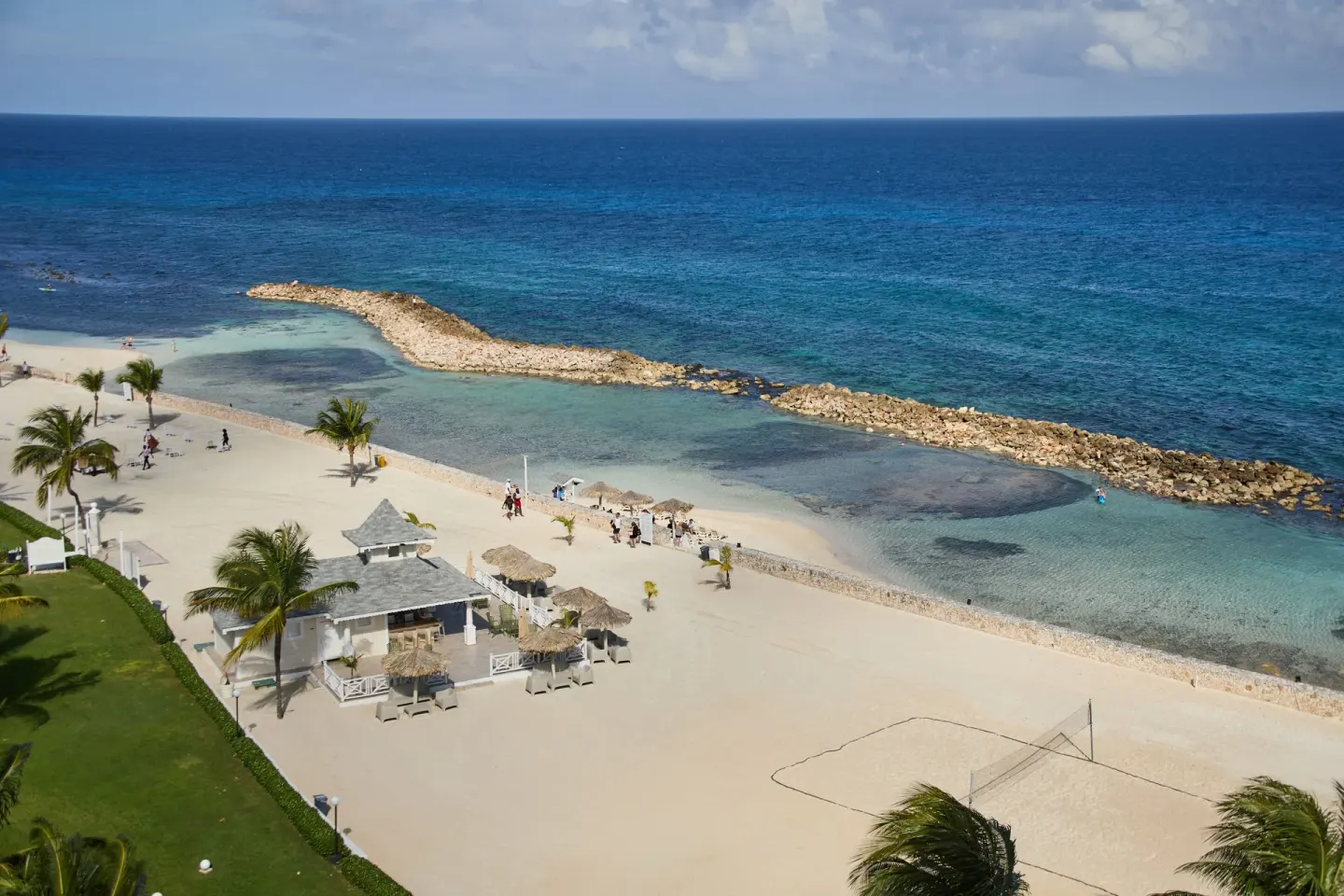Aerial beach and rocky breakwater at Bahia Principe Luxury Runaway Bay.