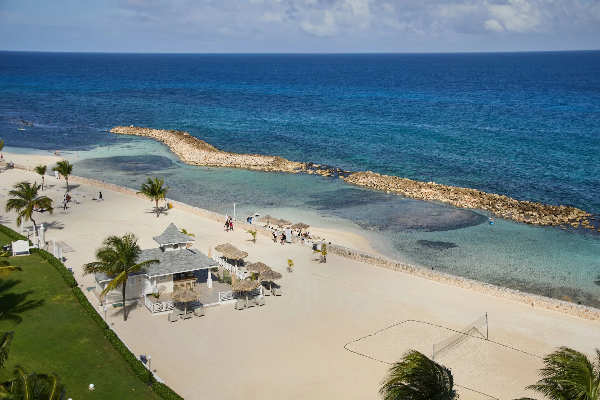 Aerial beach and rocky breakwater at Bahia Principe Luxury Runaway Bay.