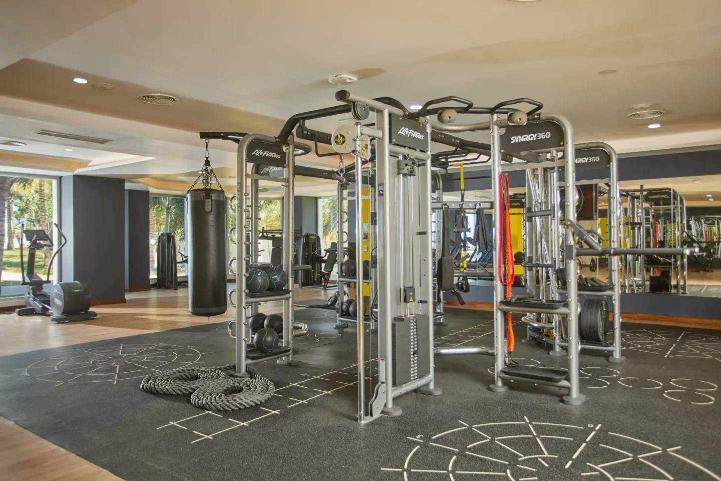 Fitness center with cable machines, punching bag and free weights at Bahia Principe Luxury Runaway Bay.