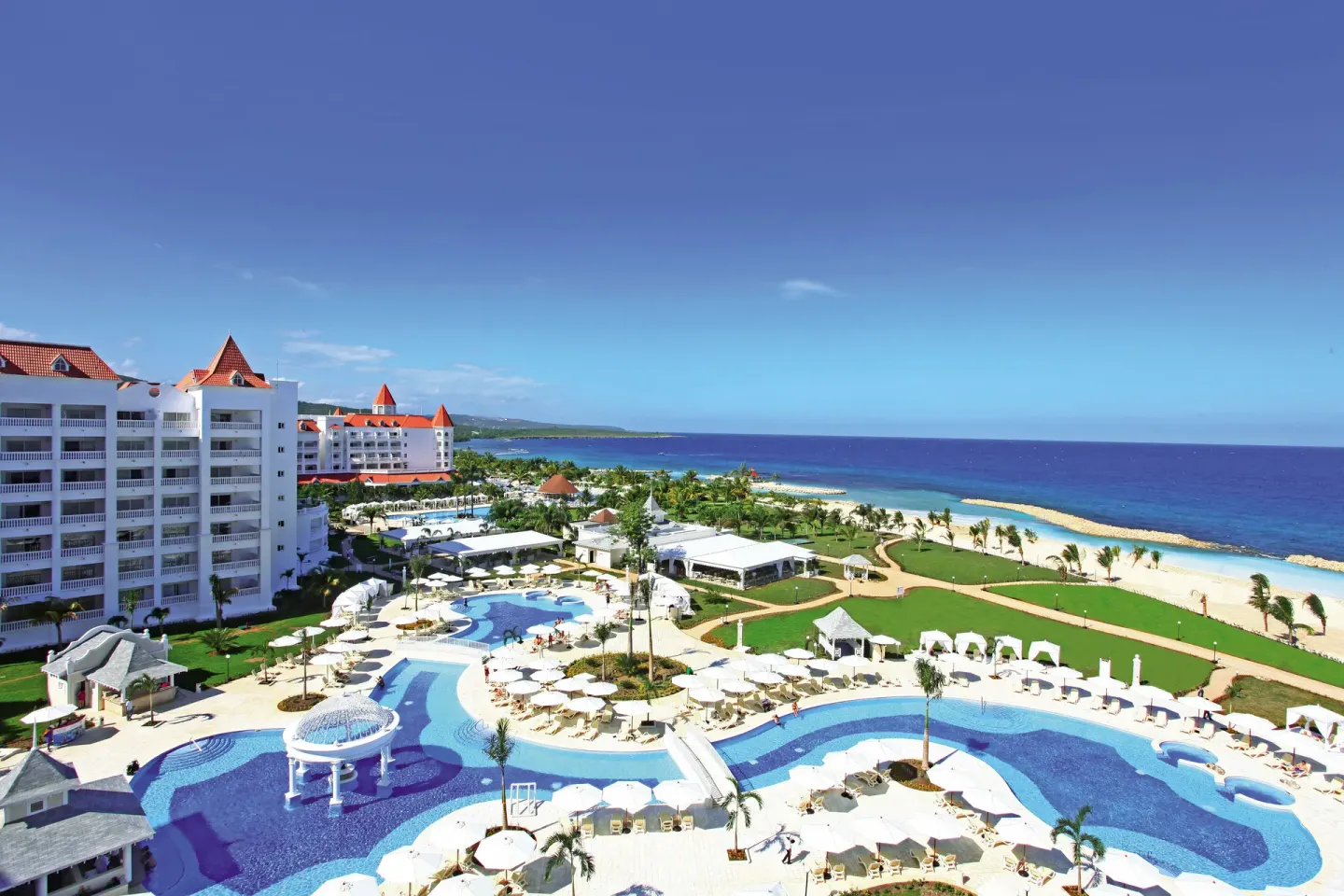 Resort pools, beach, and ocean from above at Bahia Principe Luxury Runaway Bay.