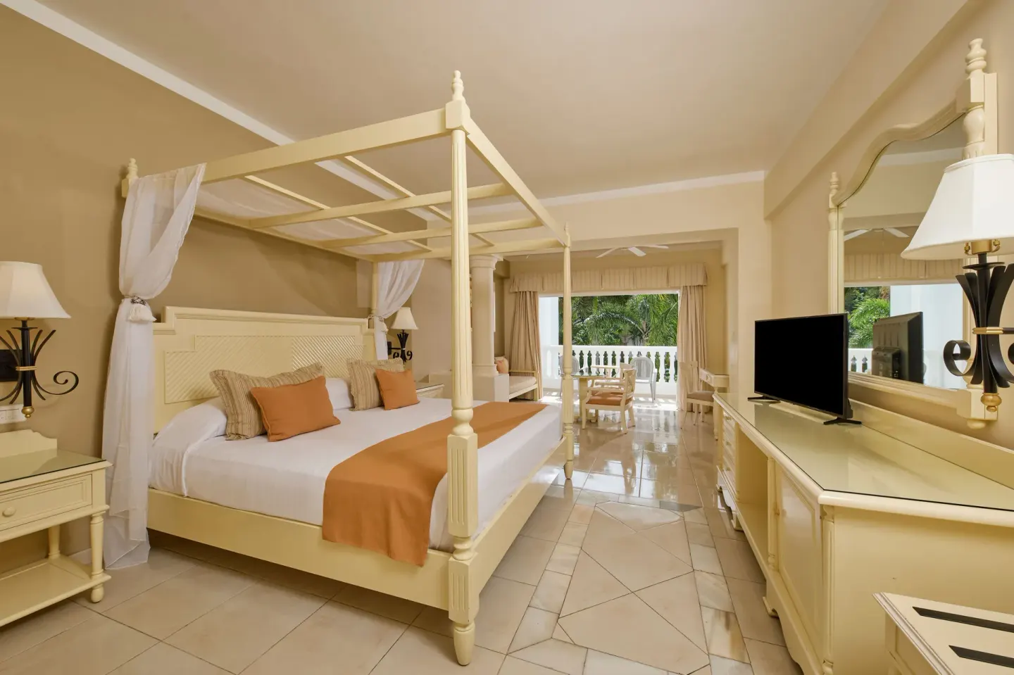 Junior Suite deluxe with four-poster bed at Bahia Principe Luxury Runaway Bay.
