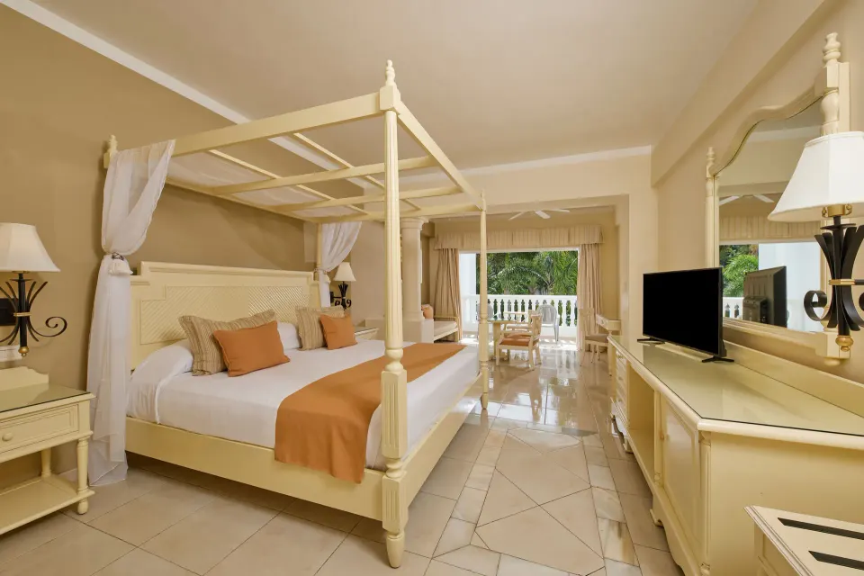 Junior Suite deluxe with four-poster bed at Bahia Principe Luxury Runaway Bay.