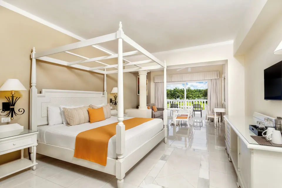 Junior Suite deluxe with four-poster bed and balcony at Bahia Principe Luxury Runaway Bay.