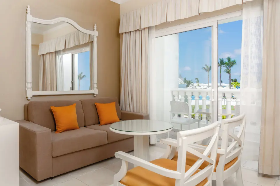 Junior Suite deluxe lounge with balcony view at Bahia Principe Luxury Runaway Bay.