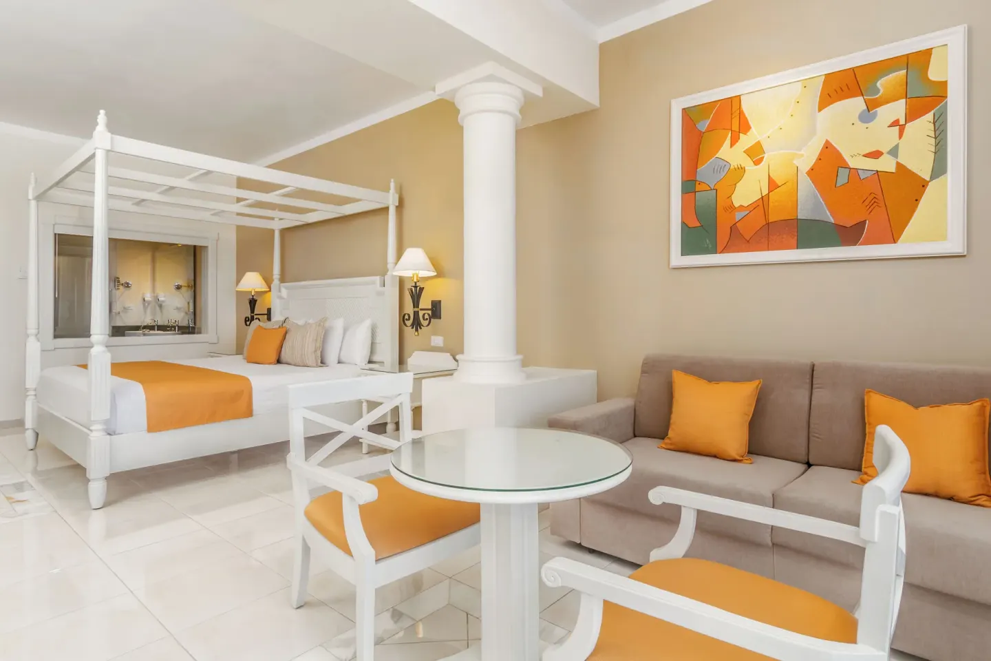 Junior Suite deluxe sitting area and four-poster bed at Bahia Principe Luxury Runaway Bay.