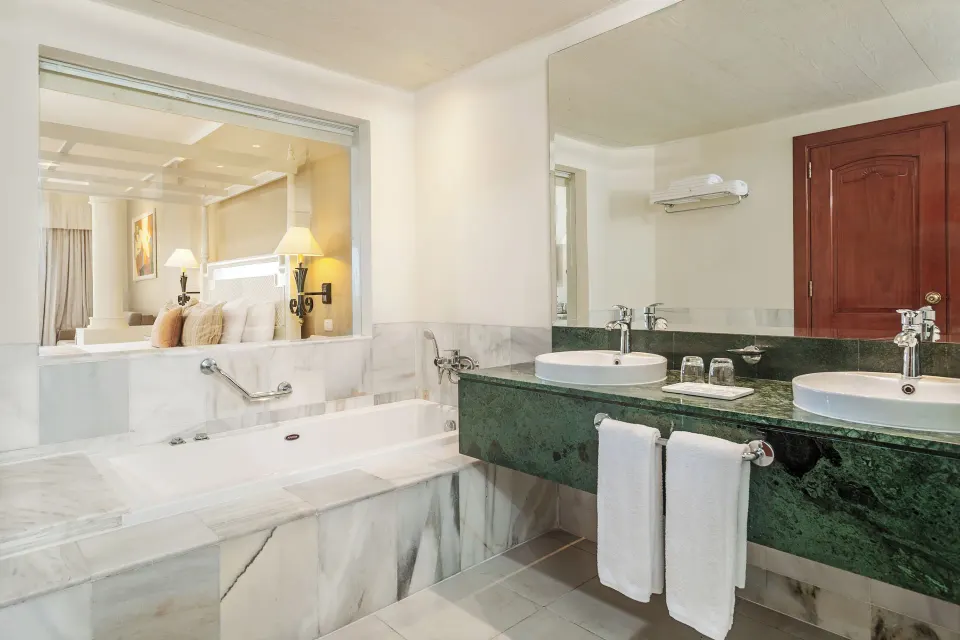 Junior Suite Sea View bathroom with tub and double sinks at Bahia Principe Luxury Runaway Bay.