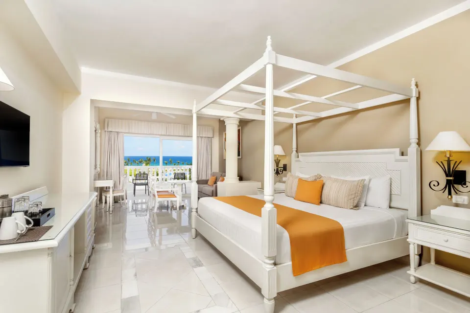Junior Suite Sea View canopy bed and balcony ocean view at Bahia Principe Luxury Runaway Bay.