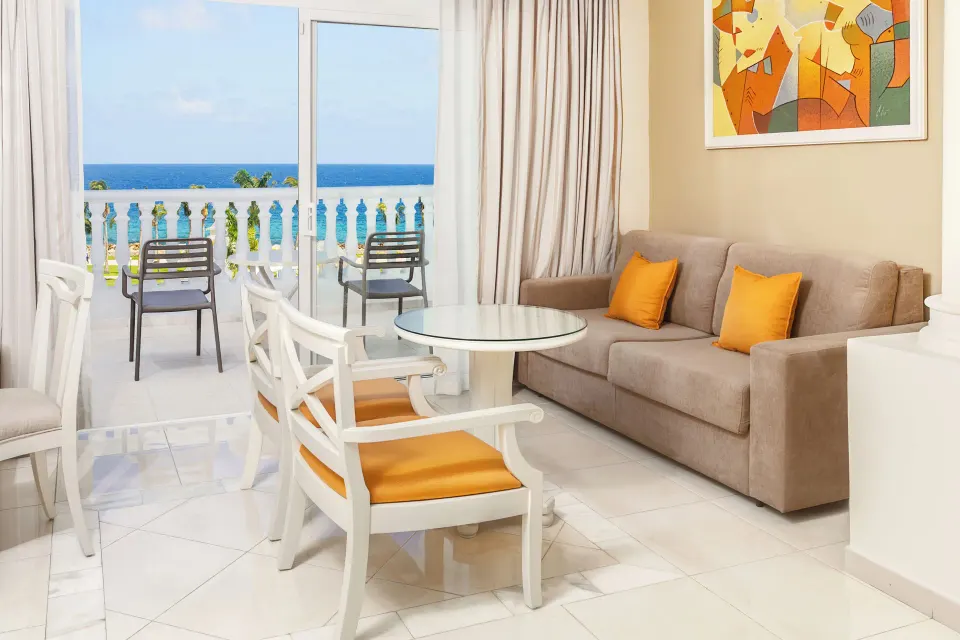 Junior Suite Sea View lounge and balcony doors at Bahia Principe Luxury Runaway Bay.