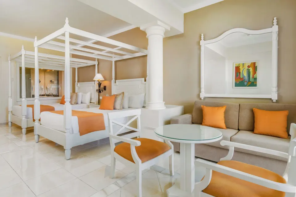 Junior Suite Sea View with two canopy beds and sofa at Bahia Principe Luxury Runaway Bay.