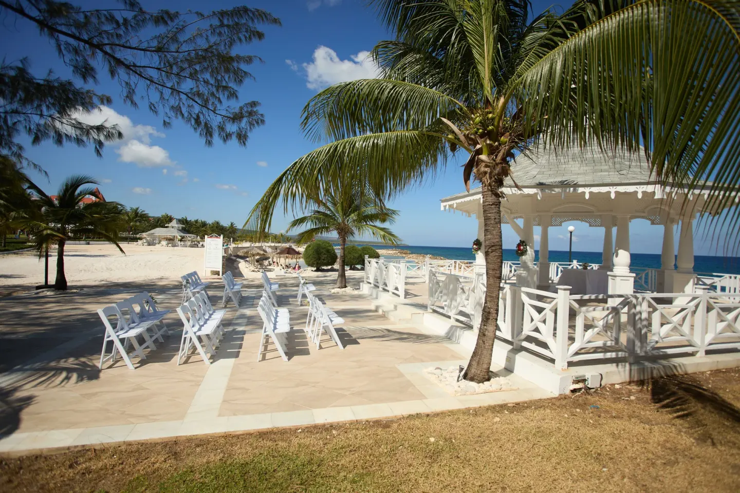Beachside wedding chairs and gazebo by the sea at Bahia Principe Luxury Runaway Bay.