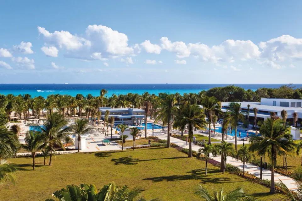 Hotel Riu Palace Mexico well-known Riu Palace all-inclusive resort with grand white architecture and beachfront pool in Playacar, Mexico.