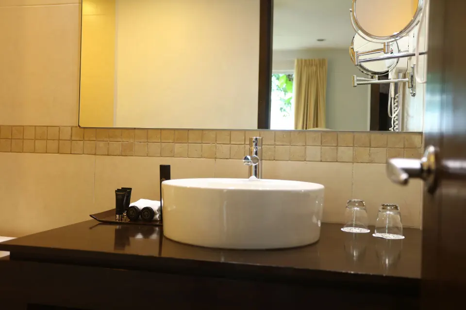 Close-up of bathroom vessel sink and mirror with amenity tray at Bahia Principe Luxury Sian Ka'an