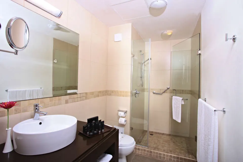 Modern bathroom with glass shower and vessel sink at Bahia Principe Luxury Sian Ka'an